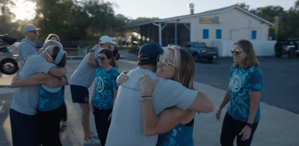 Ashley Ellis hugging supporters
